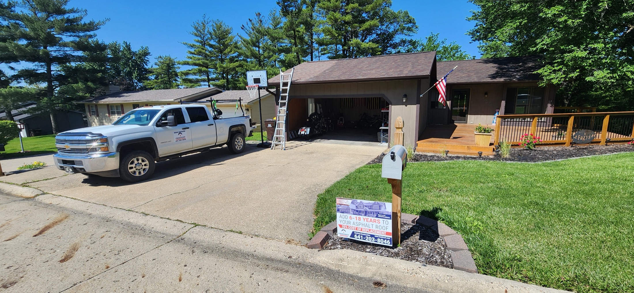 Hackney Construction truck and Fresh Roof yard sign at a residential jobsite