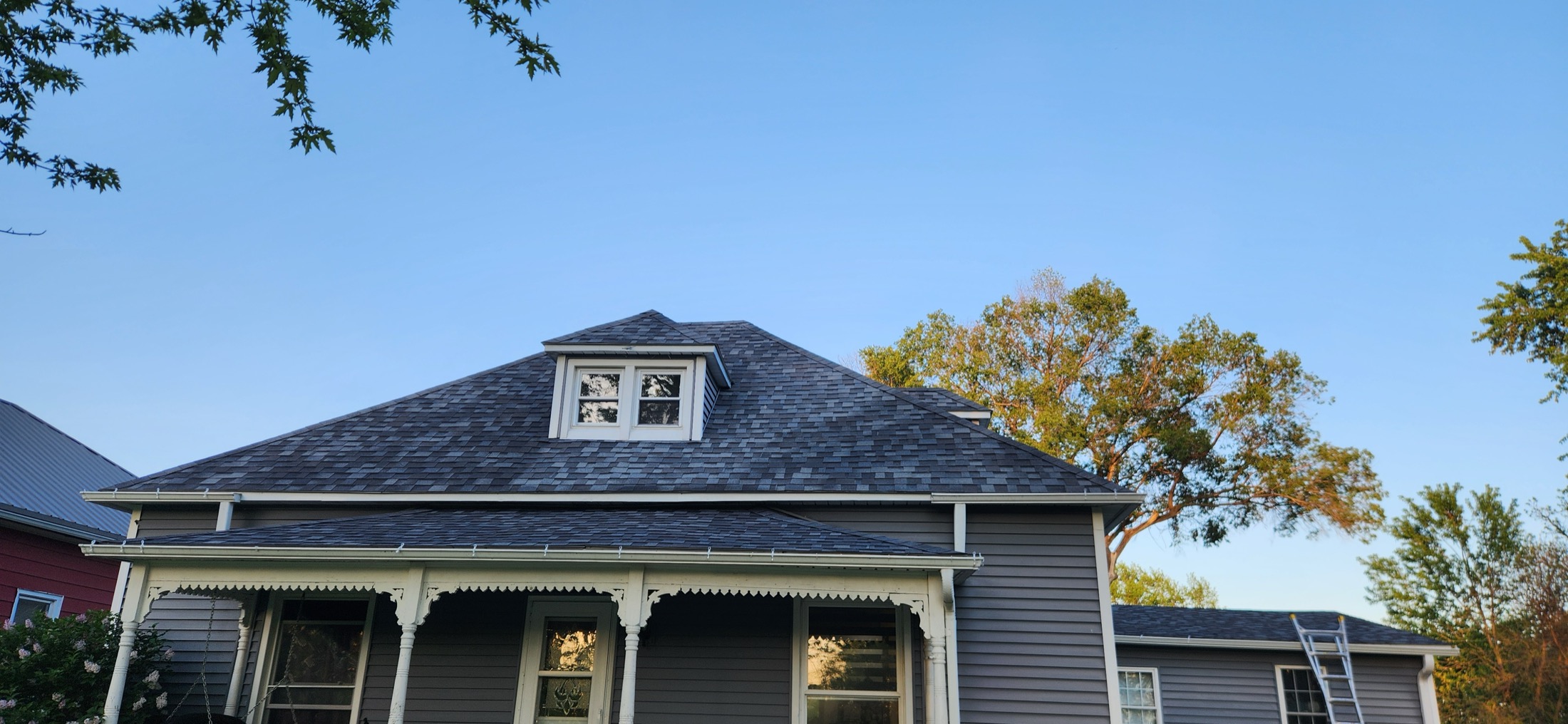 Residential asphalt shingles being inspected for roof repair